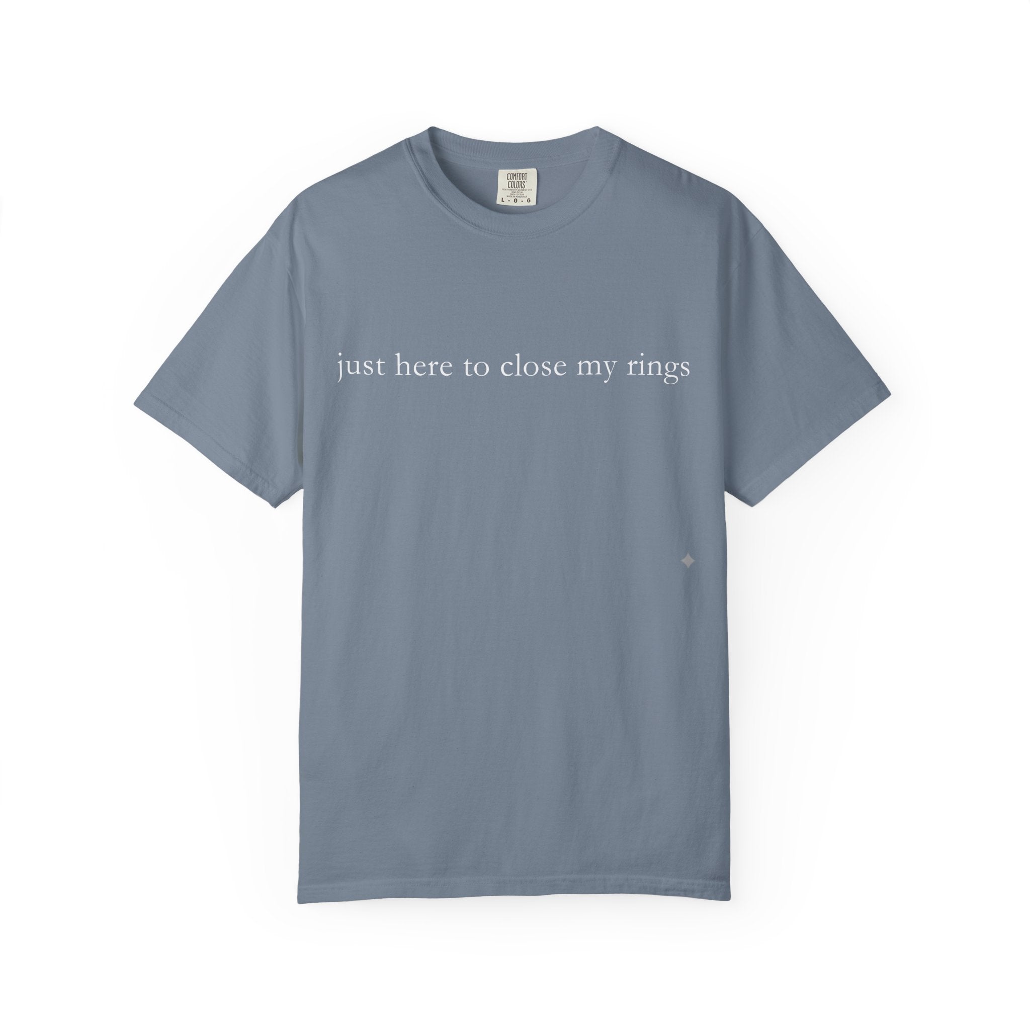Blue t-shirt with text 'just here to close my rings' on a white background