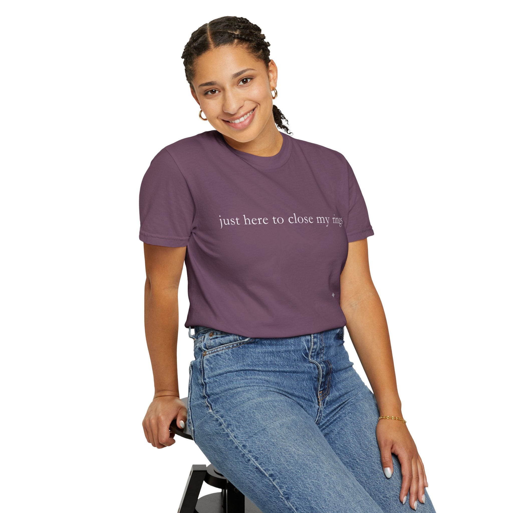Person wearing a purple t-shirt with text and blue jeans on a white background