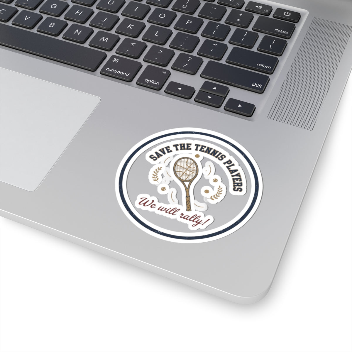 Laptop with a sticker reading 'Save the Tennis Players, We will rally!' on a white background