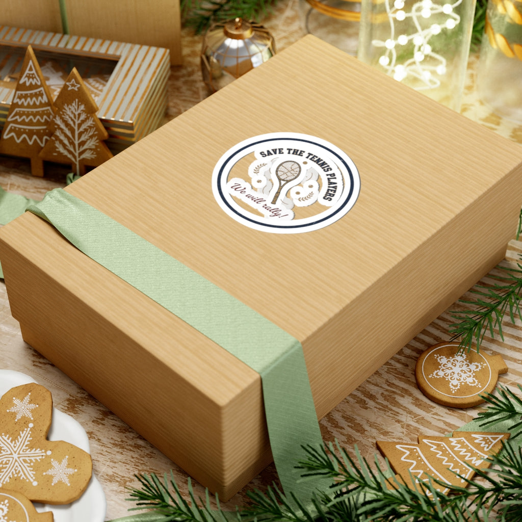 Wooden gift box with a green ribbon and a 'Save the Tennis Ladies' sticker on a festive background with cookies and decorations.
