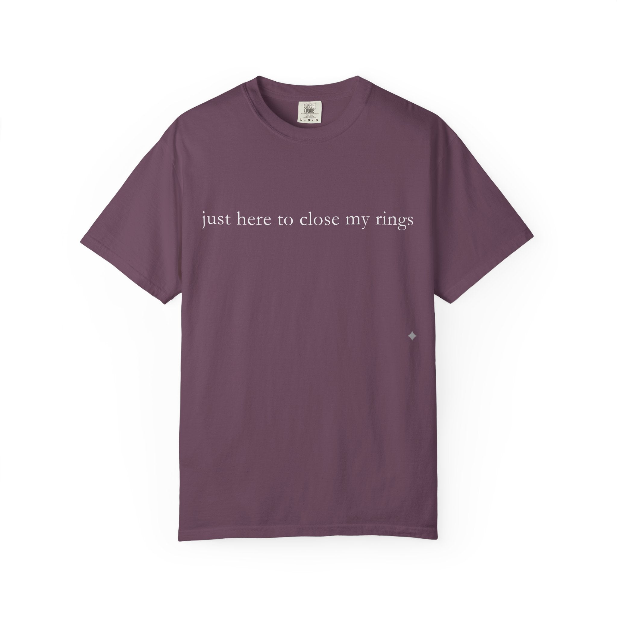 Purple t-shirt with text 'just here to close my rings' on a white background