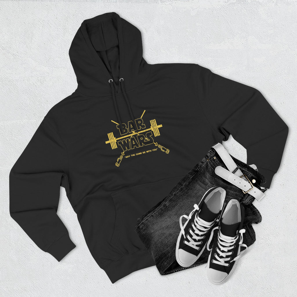 Black hoodie with gold 'BAR WARS' design, black jeans, and black sneakers on a light gray background