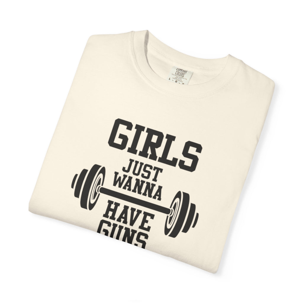 Folded t-shirt with 'Girls Just Wanna Have Guns' text and barbell graphic on a white background